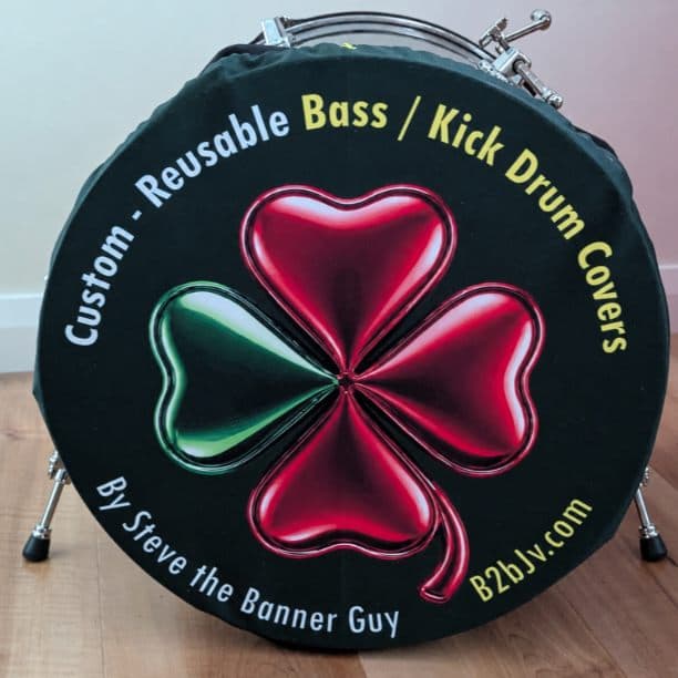 Photograph of a custom removable bass drum cover with a red and green clover, fitted over the front of a kick drum