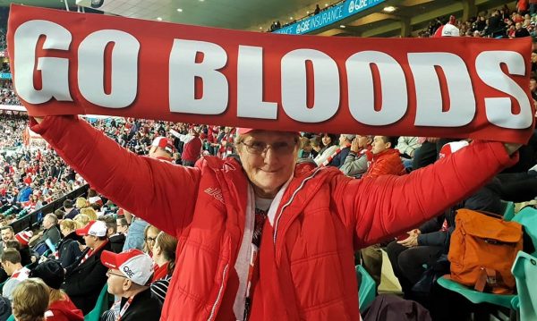 At the Game with the Go Bloods Hand Banner